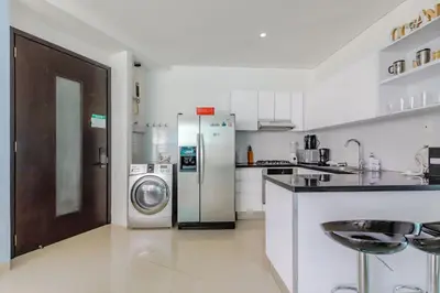 a kitchen with a refrigerator and a washer and dryer at Espectacular apartamento en Cartagena Seaway935 - Morros in Cartagena de Indias