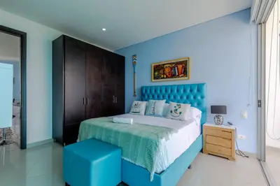 a blue bedroom with a bed and a blue headboard at Espectacular apartamento en Cartagena Seaway935 - Morros in Cartagena de Indias