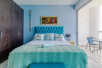 a bedroom with a large bed with a blue headboard at Espectacular apartamento en Cartagena Seaway935 - Morros in Cartagena de Indias