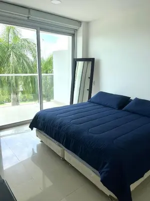 a bedroom with a blue bed and a large window at MORROS EPIC Un refugio frente al mar in Cartagena de Indias
