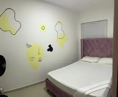 a bedroom with a bed with stickers on the wall at Apartamento 202 in Cartagena de Indias