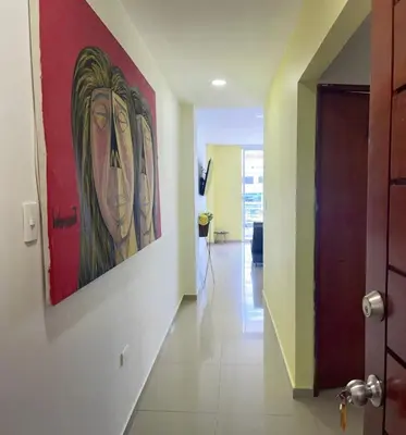 a hallway with a painting of a woman on the wall at Apartamento 202 in Cartagena de Indias