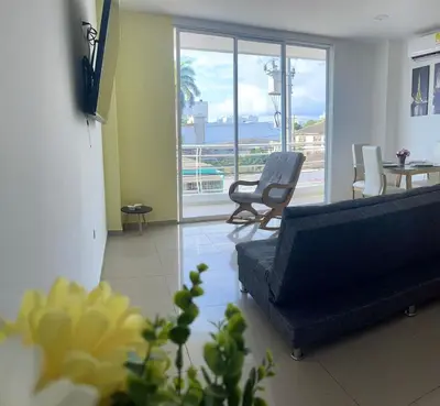 a living room with a couch and a table and chairs at Apartamento 202 in Cartagena de Indias
