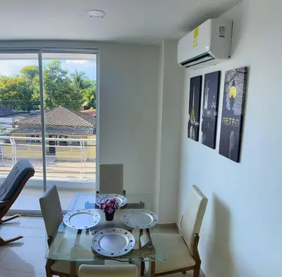 a dining room with a table and chairs and a window at Apartamento 202 in Cartagena de Indias