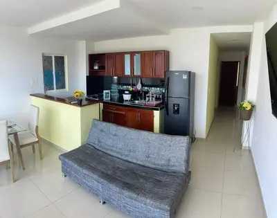 a kitchen with a couch and a refrigerator at Apartamento 202 in Cartagena de Indias