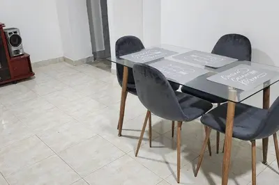 a dining room table with four chairs with signs on it at Lindo Apartamento cerca al Estadio Metropolitano in Barranquilla