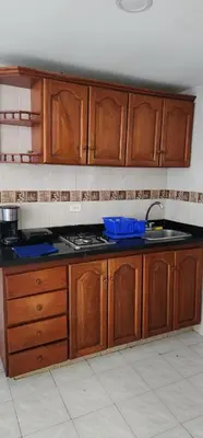 a kitchen with wooden cabinets and a counter top at Hermoso apartamento con vista al mar in Cartagena de Indias