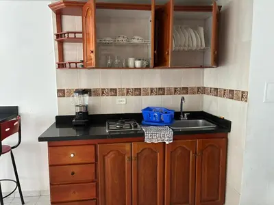 a kitchen with a sink and wooden cabinets at Hermoso apartamento con vista al mar in Cartagena de Indias