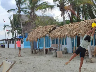 two people playing with a frisbee on the beach at Palenque Beach House in San Onofre