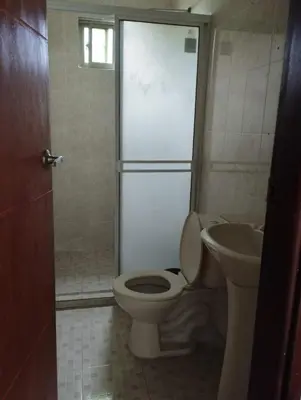 a bathroom with a toilet and a sink at Apartahotel Eden Coveñas in Coveñas