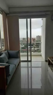 a living room with a couch and a large window at Amazing views in Barranquilla in Barranquilla