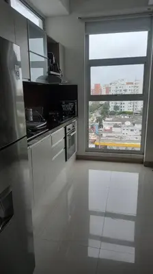 a kitchen with a large window and a white floor at Amazing views in Barranquilla in Barranquilla