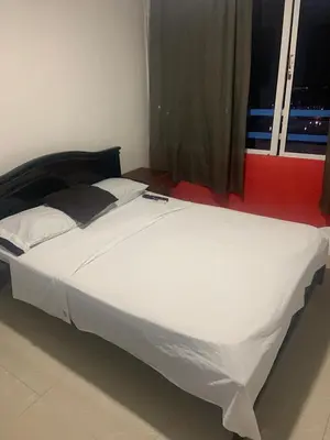 a large white bed in a room with a window at Studio Apartment E11C Near The Sea With Pool in Cartagena de Indias