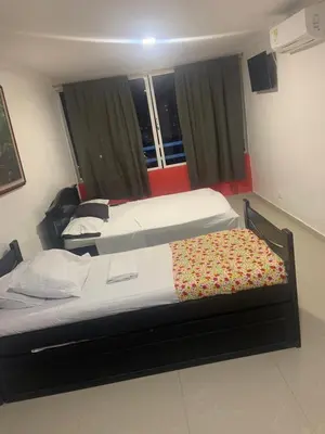 two beds in a hotel room with at Studio Apartment E11C Near The Sea With Pool in Cartagena de Indias