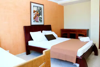 a hotel room with two beds and a table at Apartment 1C11 Near The Sea With Pool in Cartagena de Indias