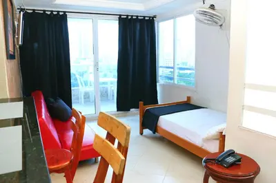 a small bedroom with a bed and a window at Apartment 1C11 Near The Sea With Pool in Cartagena de Indias