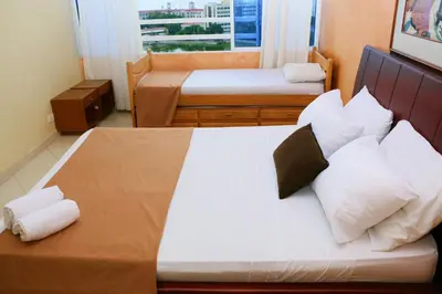 a bedroom with two beds with white sheets and pillows at Apartment 1C11 Near The Sea With Pool in Cartagena de Indias