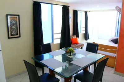 a dining room with a table and chairs and a bedroom at Apartment 1C19 Close To The Sea With Pool in Cartagena de Indias