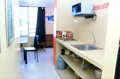 a kitchen with a sink and a microwave at Apartment 1C19 Close To The Sea With Pool in Cartagena de Indias