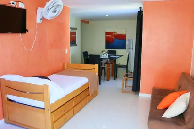 a bedroom with a bed and a living room at Apartment 1C19 Close To The Sea With Pool in Cartagena de Indias
