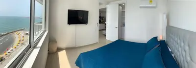 a room with a bed and a view of the beach at Apartment al-2 facing the sea with Wifi in Cartagena de Indias