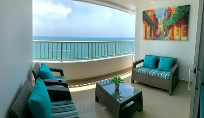 a living room with a balcony with a view of the ocean at Apartment al-2 facing the sea with Wifi in Cartagena de Indias