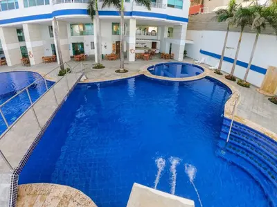 a large swimming pool in front of a hotel at Apartment al-1 facing the sea with pool and Wifi in Cartagena de Indias