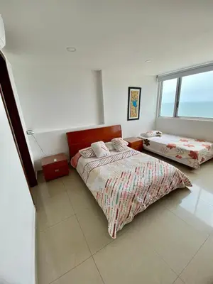 a bedroom with two beds and a window at Apartment al-1 facing the sea with pool and Wifi in Cartagena de Indias
