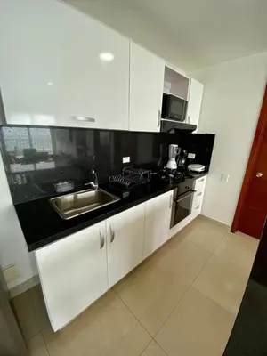 a kitchen with white cabinets and a stainless steel sink at Apartment al-1 facing the sea with pool and Wifi in Cartagena de Indias