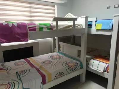 a room with two bunk beds and a bed at 3MR8 Duplex Apartment Close To The Sea With Pool in Cartagena de Indias
