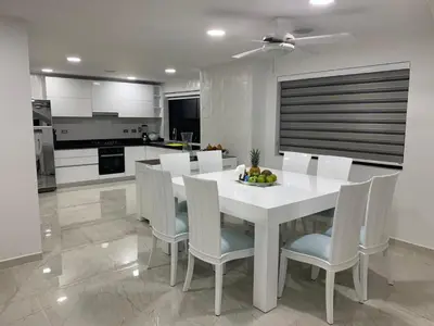 a kitchen with a white dining room table and chairs at 3MR8 Duplex Apartment Close To The Sea With Pool in Cartagena de Indias