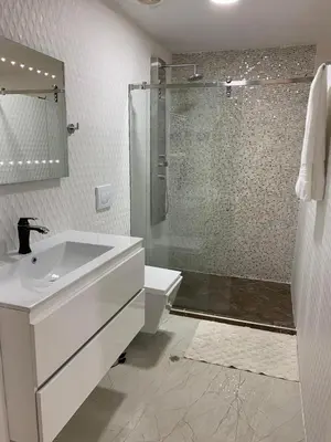 a white bathroom with a sink and a shower at 3MR8 Duplex Apartment Close To The Sea With Pool in Cartagena de Indias