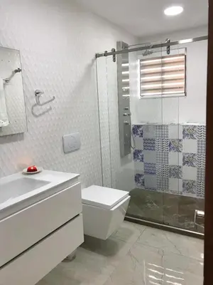 a white bathroom with a toilet and a shower at 3MR8 Duplex Apartment Close To The Sea With Pool in Cartagena de Indias
