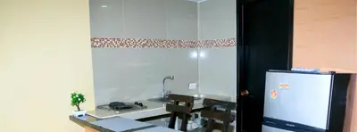 a kitchen with a refrigerator and a table in it at Studio Apartment E19C Close To The Sea And Pool in Cartagena de Indias