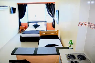 a small room with two beds and a kitchen at Studio Apartment E19C Close To The Sea And Pool in Cartagena de Indias