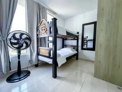 a bedroom with two bunk beds and a fan at Aqualina 42M2/3 cuadras playa in Cartagena de Indias
