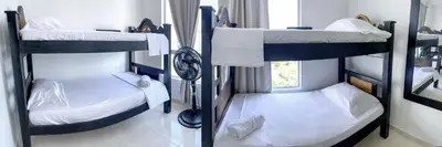 a room with three bunk beds and a window at Aqualina 42M2/3 cuadras playa in Cartagena de Indias