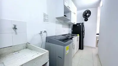 a small kitchen with a sink and a refrigerator at Aqualina 42M2/3 cuadras playa in Cartagena de Indias