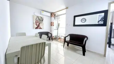 a dining room with a table and chairs in a room at Aqualina 42M2/3 cuadras playa in Cartagena de Indias