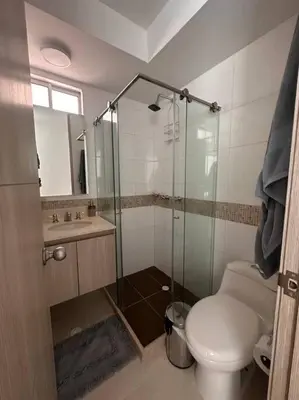 a bathroom with a toilet and a glass shower at Apartamento en Barranquilla Zona Norte Miramar in Barranquilla