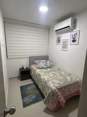 a small bedroom with a bed and a window at Apartamento en Barranquilla Zona Norte Miramar in Barranquilla