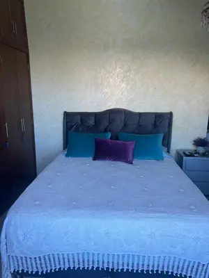 a bed with a purple and blue pillow on it at Exquisite apartment in El Laguito Cartagena in Cartagena de Indias
