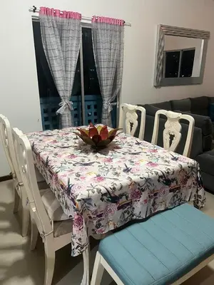 a dining room table and chairs with a floral table cloth at Exquisite apartment in El Laguito Cartagena in Cartagena de Indias