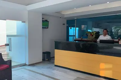 a man standing behind a counter in a restaurant at Exquisite apartment in El Laguito Cartagena in Cartagena de Indias