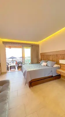 a large bedroom with a large bed and a balcony at Suite privada frente al mar, Tolú in San Silvestre