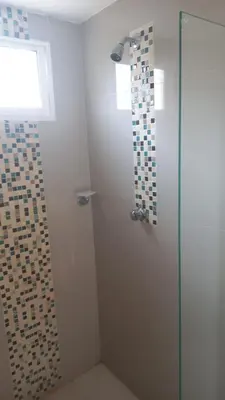 a bathroom with a shower with a glass door at 3 bedroom apartment 3CL3 in the old center in Cartagena de Indias