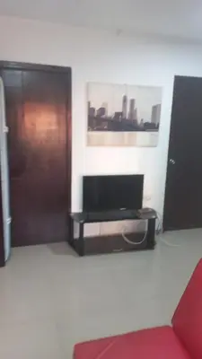 a living room with a red couch and a television at 3 bedroom apartment 3CL3 in the old center in Cartagena de Indias