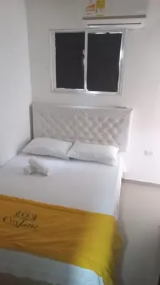 a bedroom with a white bed with a window at 3 bedroom apartment 3CL3 in the old center in Cartagena de Indias