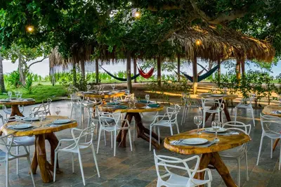 a group of tables and chairs at a restaurant at Hotel Rosario de Mar by Tequendama in Isla Grande