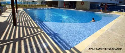 a man is sitting in a swimming pool at Apartamentos Bacanos in Cartagena de Indias